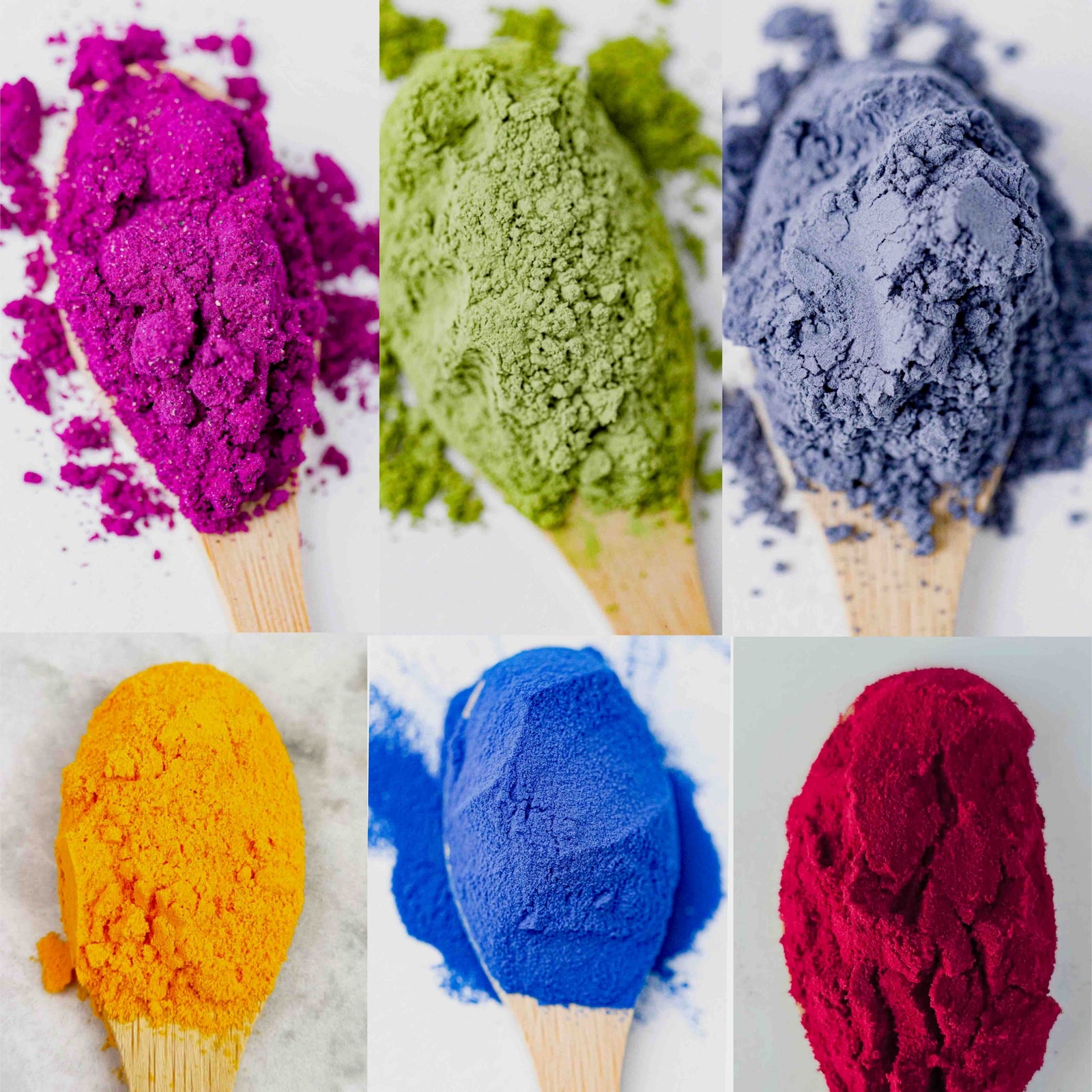 olorful botanical ingredient powders in purple, green, blue, yellow, bright blue and deep red on wooden spoons