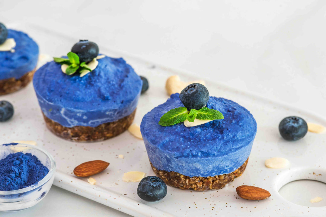 Vegan dessert cups colored with blue spirulina – vibrant natural blue cheesecake-style treats
