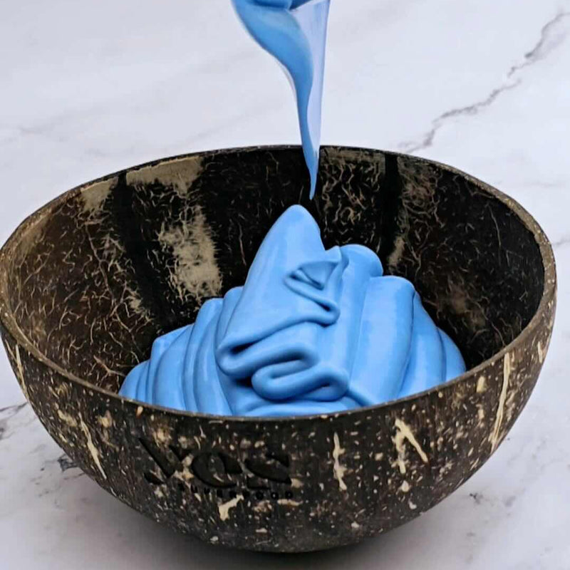 Blue Spirulina Powder smoothie bowl with natural blue food coloring in a coconut bowl.