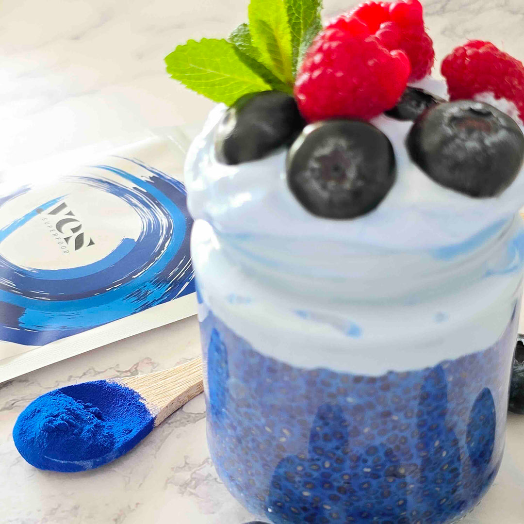 Blue Spirulina Powder chia dessert with berries and natural blue food coloring powder.surface
