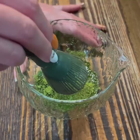 Yes Superfood Ceremonial Matcha powder being mixed with water, showing its smooth texture and vibrant green color.