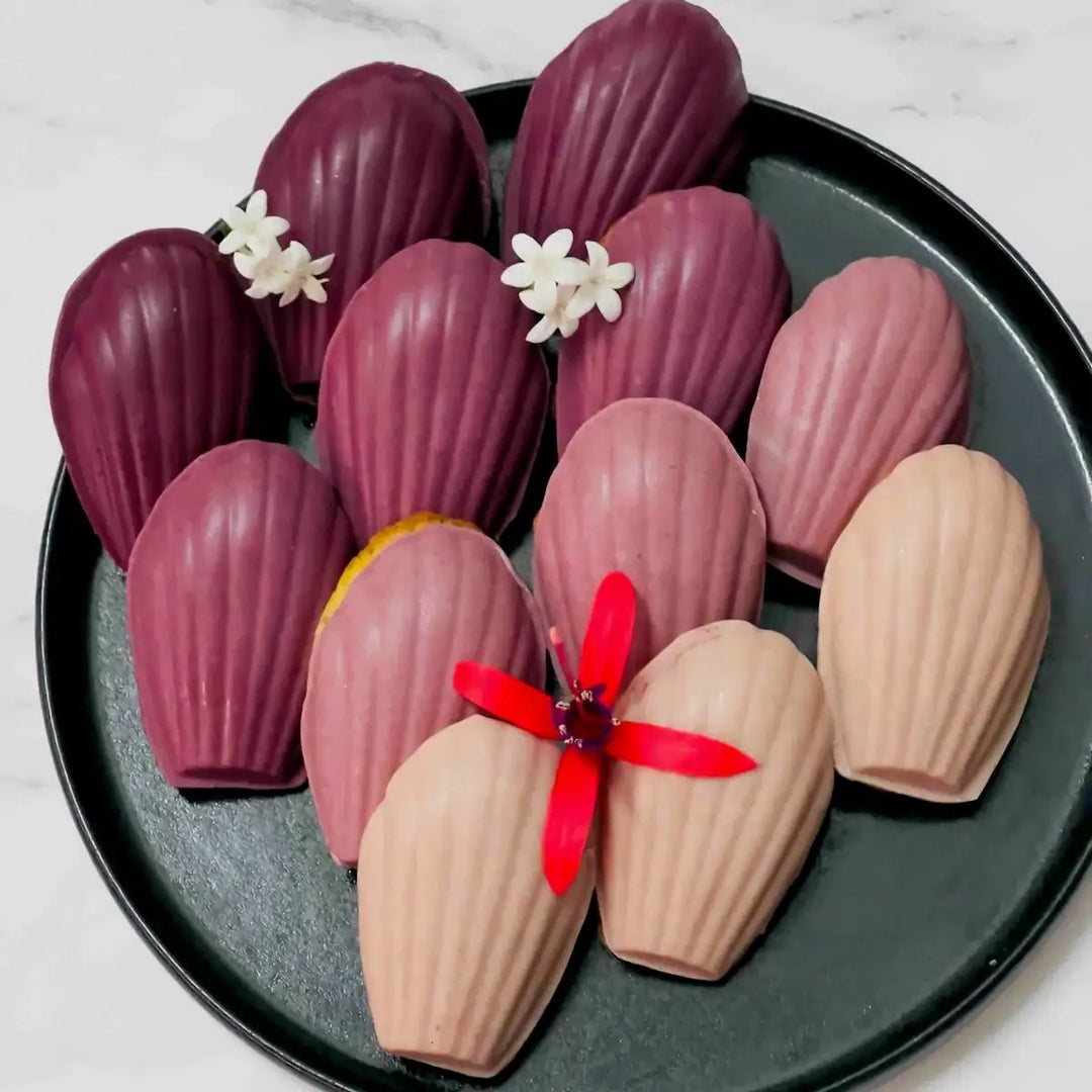 Black Carrot Powder used to colour white chocolate glaze in different pink, purple and burgundy shades