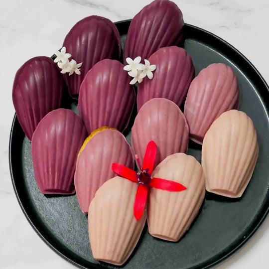 Black Carrot Powder used to colour white chocolate glaze in different pink, purple and burgundy shades