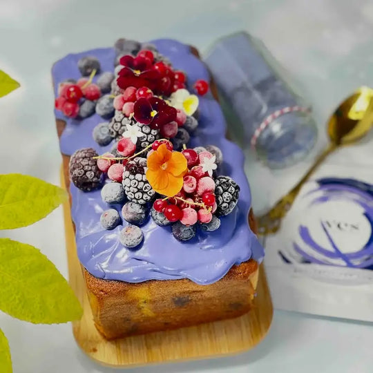 Butterfly Pea Powder used to create a naturally purple cake topping with berries